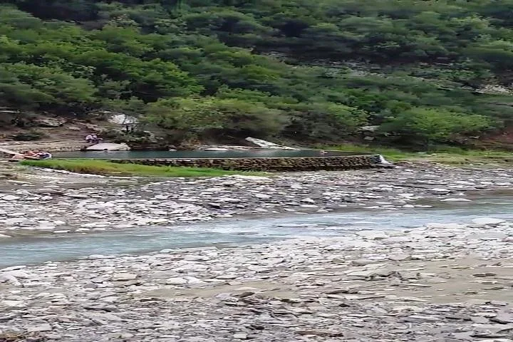 Fluss mit felsigen Ufern und einem kleinen Wasserbecken.